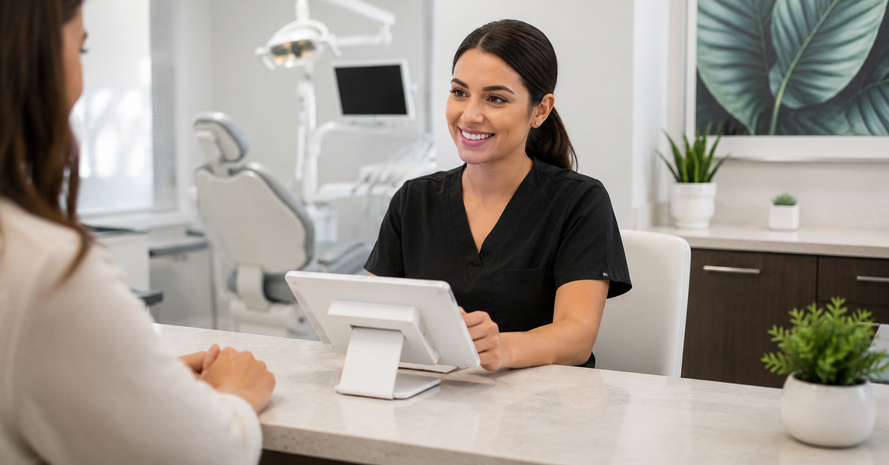 Dental office front desk staff processing patient payment with dual pricing terminal